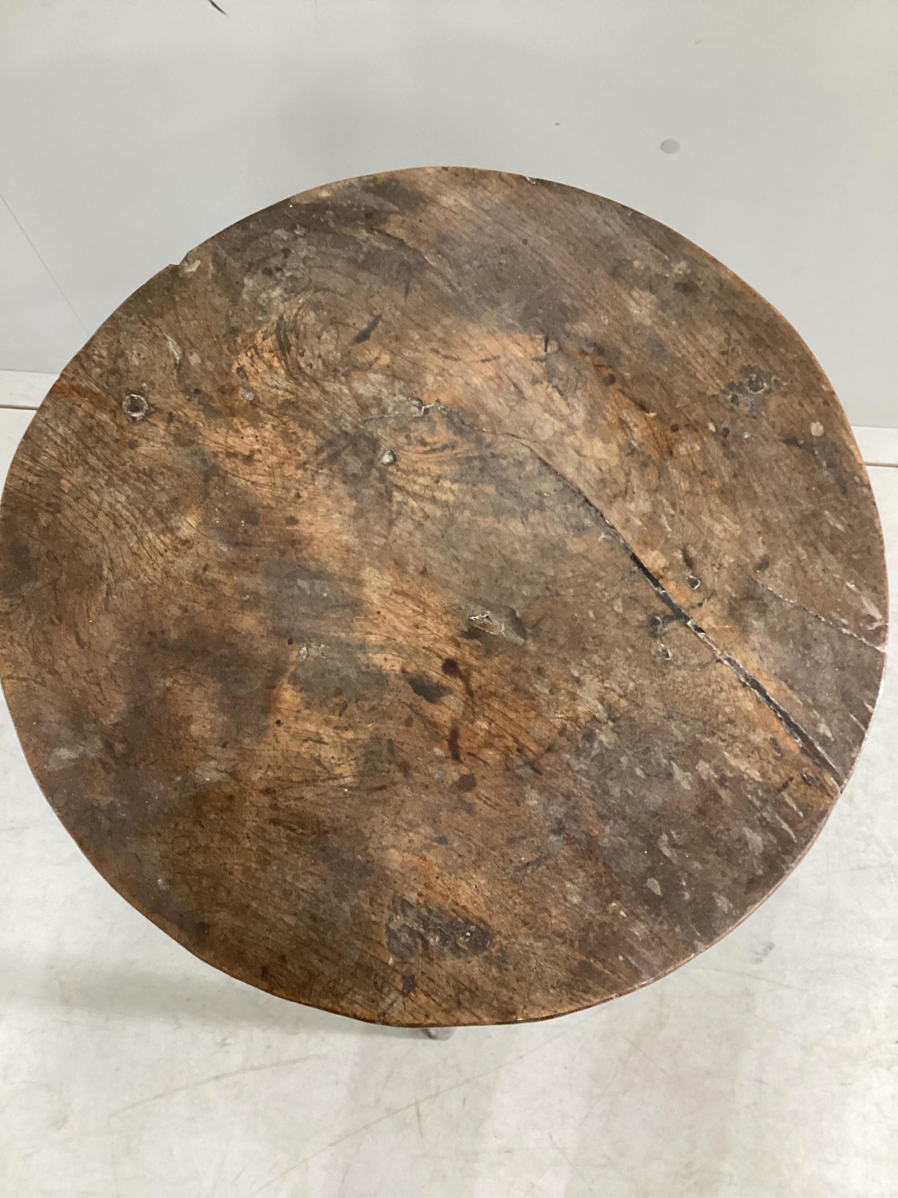 An early 19th century elm and fruitwood cricket table, diameter 46cm, height 66cm. Condition - fair